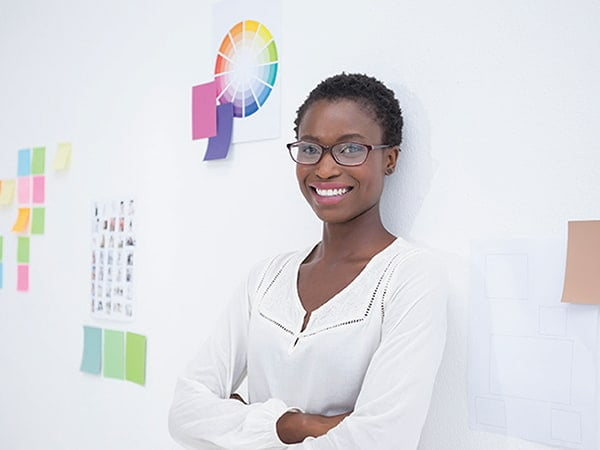 woman smiling standing against wall