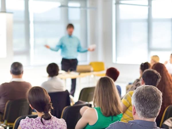 Man Presenting in Front of Audience About Presentation Skills