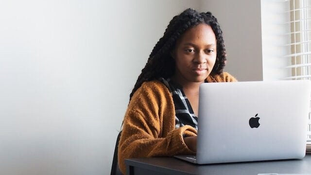 Woman on a laptop obtaining her HR certification